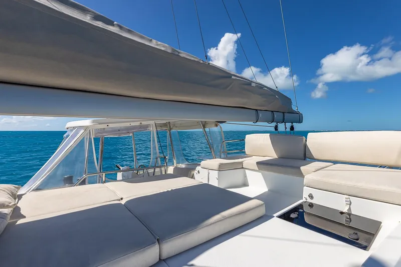Happy Here Yacht Photos Pics 2020 Fountaine Pajot Saona 47 catamaran with spacious deck, sailing on clear blue ocean.