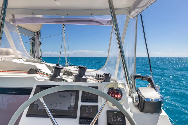 Happy Here Yacht Photos Pics Cockpit view of 2020 Fountaine Pajot Saona 47 sailing on clear blue ocean.