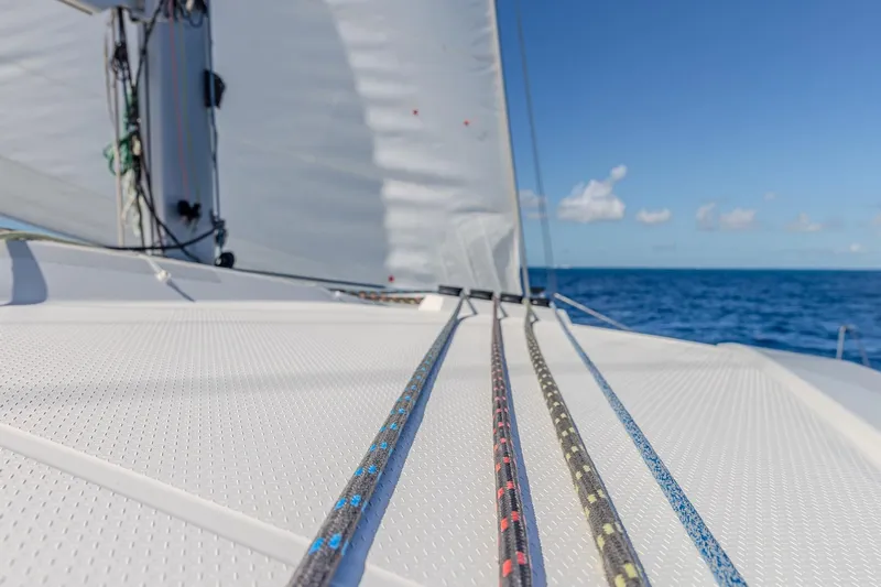 Happy Here Yacht Photos Pics 2020 Fountaine Pajot Saona 47 catamaran sailing on open sea with clear blue sky.