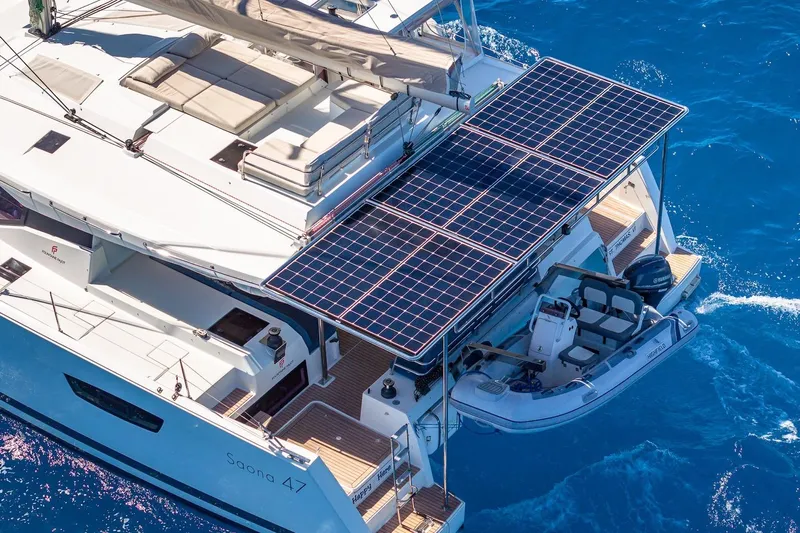 Happy Here Yacht Photos Pics 2020 Fountaine Pajot Saona 47 catamaran with solar panels and tender on blue ocean.