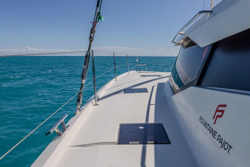 Happy Here Yacht Photos Pics 2020 Fountaine Pajot Saona 47 catamaran sailing on clear blue ocean waters.