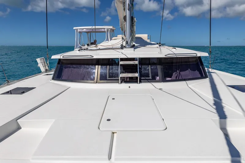 Happy Here Yacht Photos Pics 2020 Fountaine Pajot Saona 47 catamaran on open sea under clear blue sky.