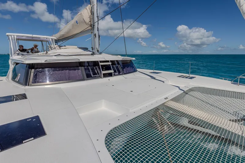 Happy Here Yacht Photos Pics 2020 Fountaine Pajot Saona 47 catamaran sailing on clear blue ocean.