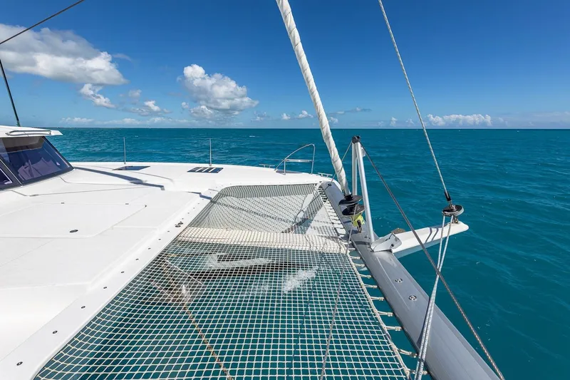 Happy Here Yacht Photos Pics Fountaine Pajot Saona 47 catamaran sailing on clear blue ocean, 2020 model.