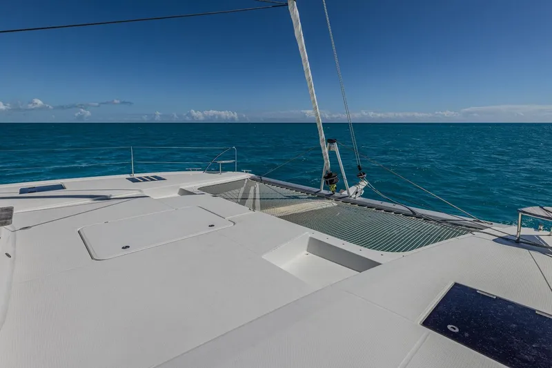 Happy Here Yacht Photos Pics 2020 Fountaine Pajot Saona 47 catamaran on open sea, clear blue sky, and ocean view.