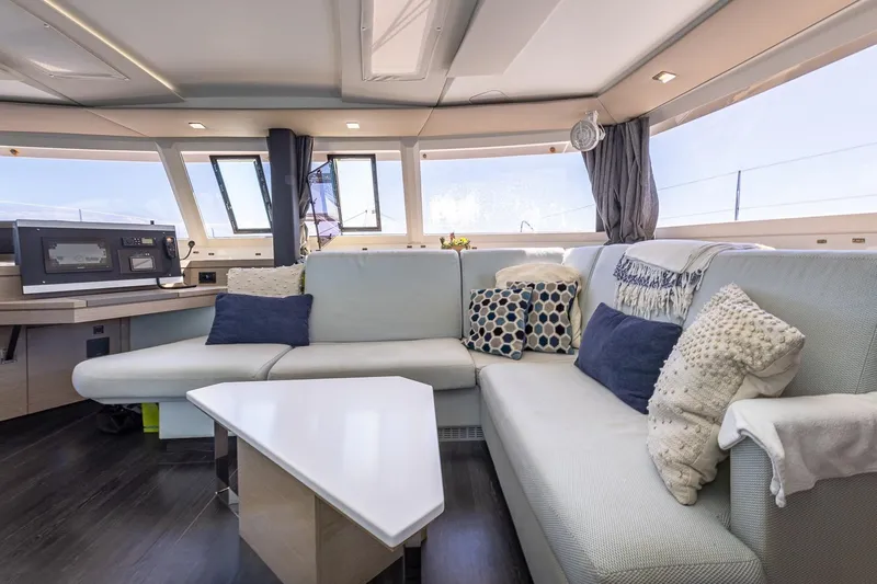 Happy Here Yacht Photos Pics Luxurious interior of 2020 Fountaine Pajot Saona 47 catamaran with modern seating and decor.