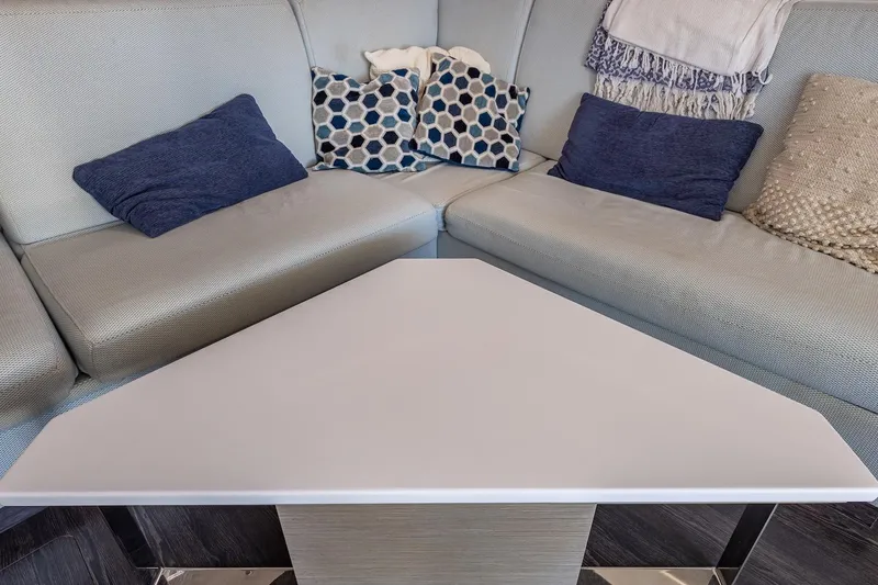 Happy Here Yacht Photos Pics Interior of 2020 Fountaine Pajot Saona 47 with cozy seating and decorative pillows.