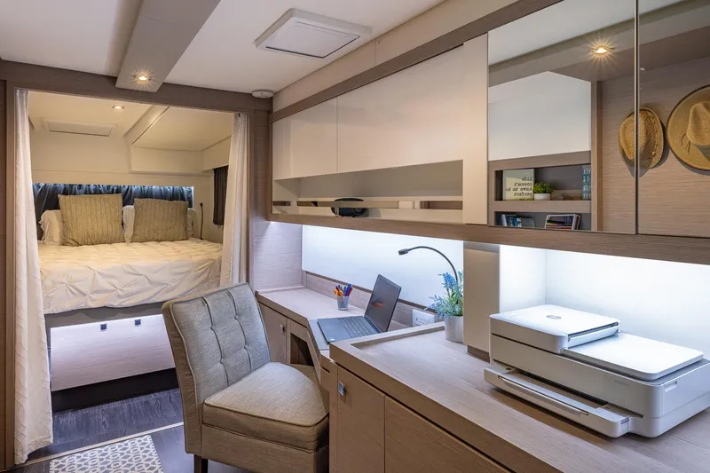 Happy Here Yacht Photos Pics Luxurious interior of 2020 Fountaine Pajot Saona 47 yacht with cozy bedroom and modern workspace.