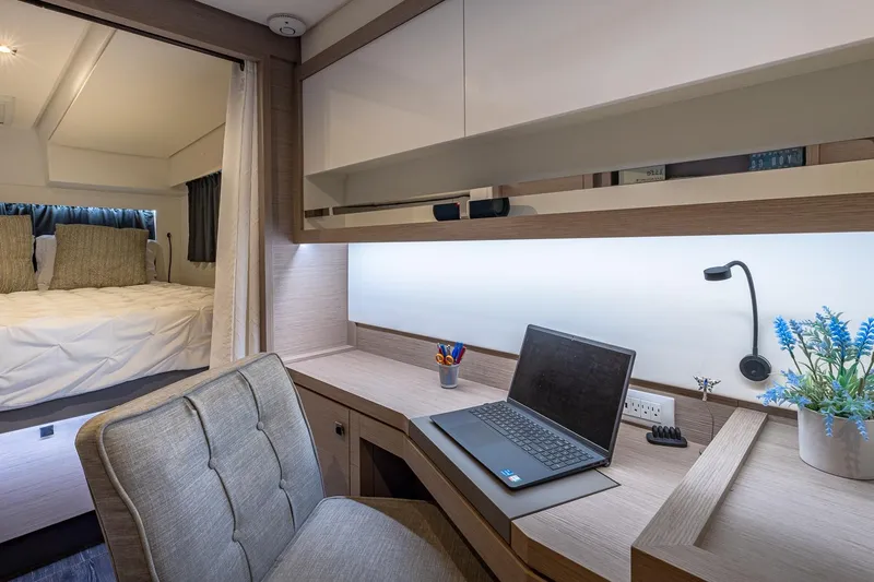 Happy Here Yacht Photos Pics Modern workspace on 2020 Fountaine Pajot Saona 47 yacht with laptop and cozy bedroom.