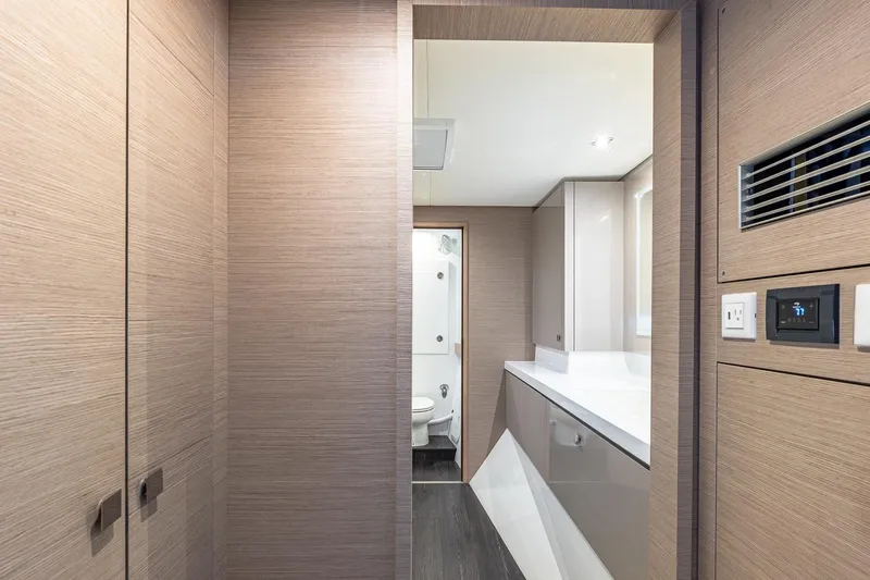 Happy Here Yacht Photos Pics Modern bathroom interior on 2020 Fountaine Pajot Saona 47 yacht, featuring sleek wood paneling.