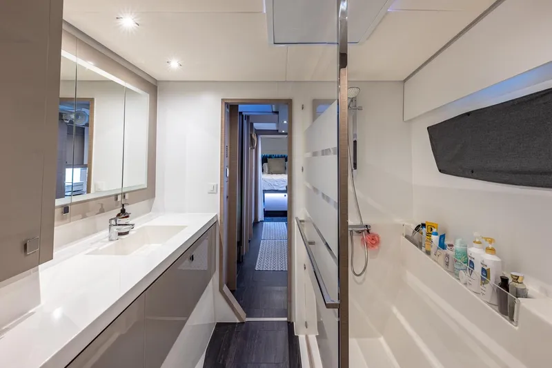Happy Here Yacht Photos Pics Modern bathroom interior of 2020 Fountaine Pajot Saona 47 catamaran, featuring sleek design and amenities.