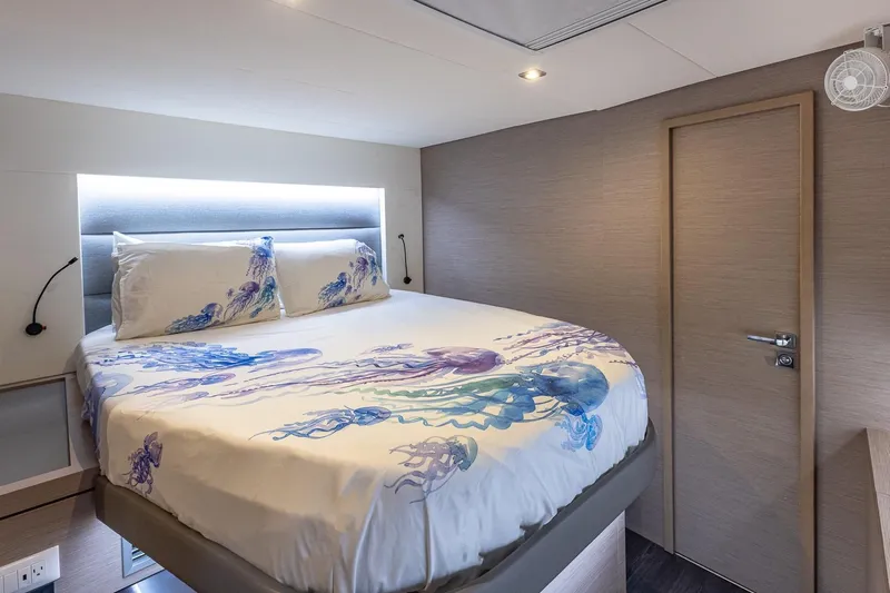 Happy Here Yacht Photos Pics Luxurious bedroom interior on 2020 Fountaine Pajot Saona 47 yacht with jellyfish-themed bedding.