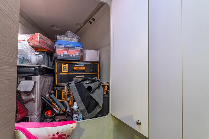 Happy Here Yacht Photos Pics Storage area on 2020 Fountaine Pajot Saona 47 yacht, filled with tools and supplies.