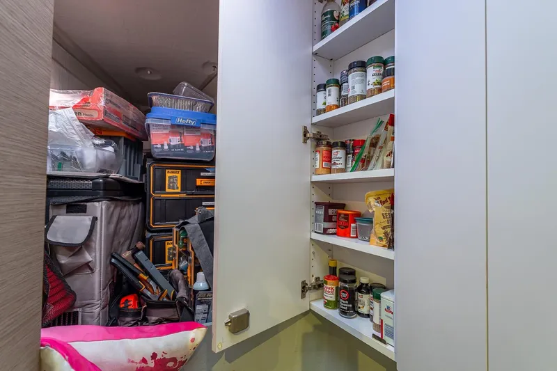 Happy Here Yacht Photos Pics Storage cabinet with spices and tools on a 2020 Fountaine Pajot Saona 47 yacht.