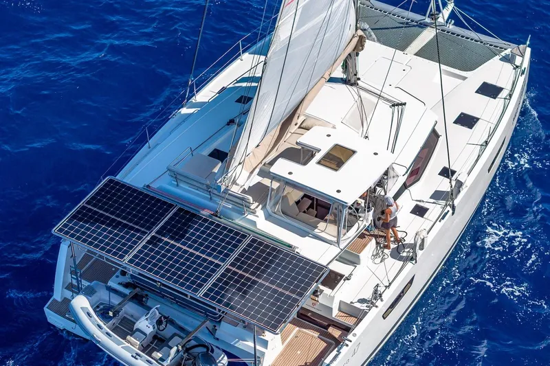 Happy Here Yacht Photos Pics 2020 Fountaine Pajot Saona 47 catamaran sailing on blue ocean with solar panels.