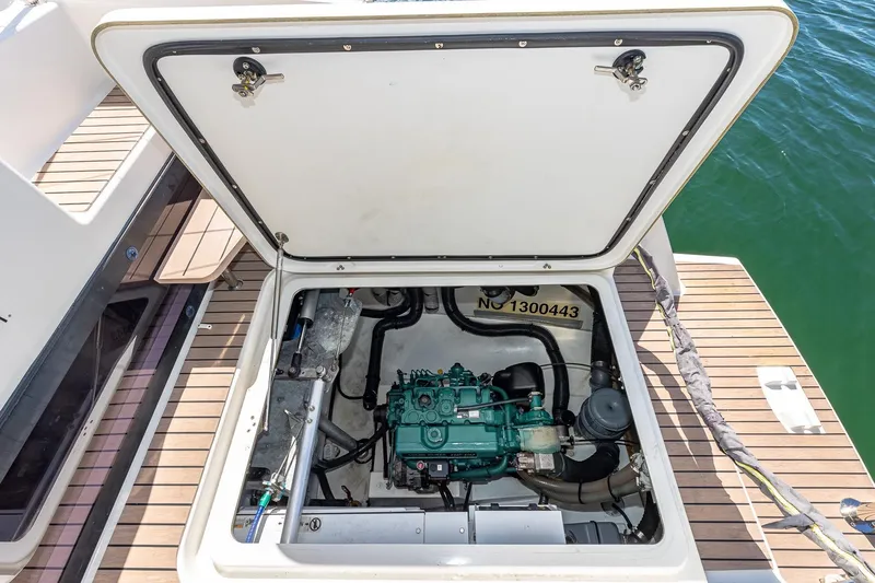 Happy Here Yacht Photos Pics Engine compartment of 2020 Fountaine Pajot Saona 47 catamaran, open hatch, docked on water.