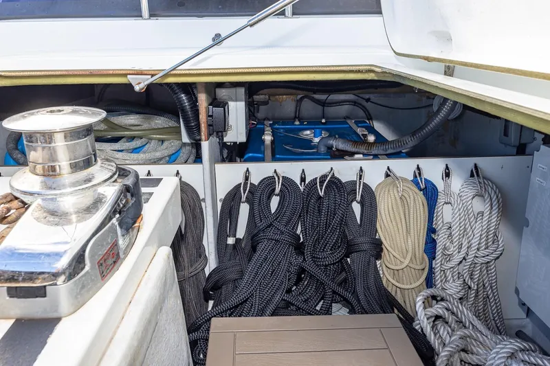 Happy Here Yacht Photos Pics Storage compartment of 2020 Fountaine Pajot Saona 47 with neatly organized ropes and winch.