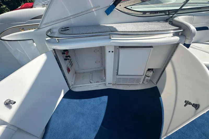  Yacht Photos Pics 2007 Formula 400 Super Sport boat interior with open storage compartments and blue carpet.