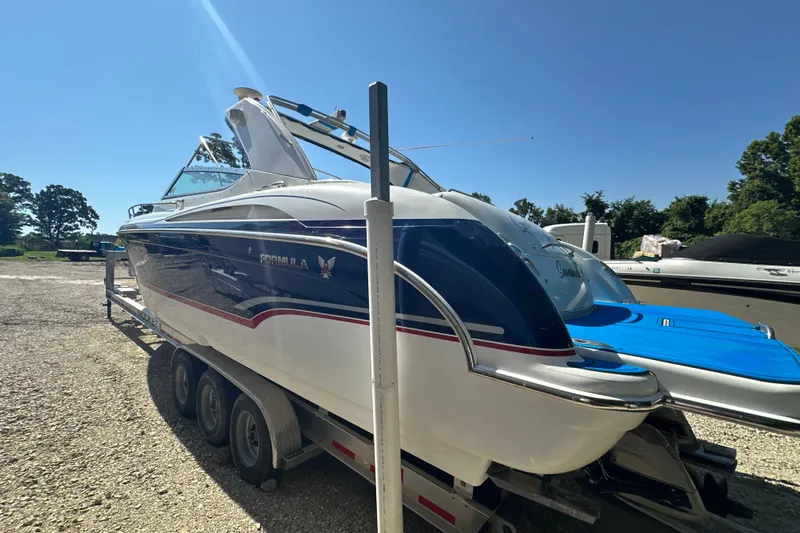  Yacht Photos Pics 2007 Formula 400 Super Sport boat on trailer, parked outdoors under clear blue sky.