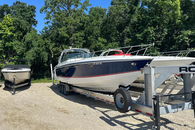  Yacht Photos Pics 2007 Formula 400 Super Sport boat on trailer, surrounded by trees.