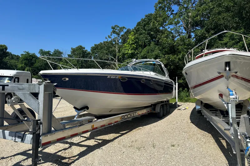  Yacht Photos Pics 2007 Formula 400 Super Sport boat on trailer, parked outdoors with trees in background.