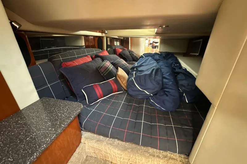  Yacht Photos Pics Cozy cabin interior of 2007 Formula 400 Super Sport with plaid bedding and pillows.