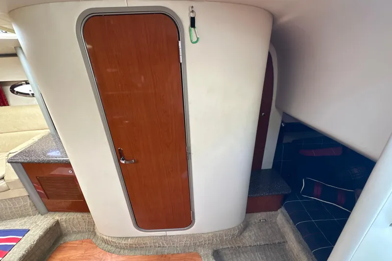  Yacht Photos Pics Interior of a 2007 Formula 400 Super Sport boat with wooden door and seating area.