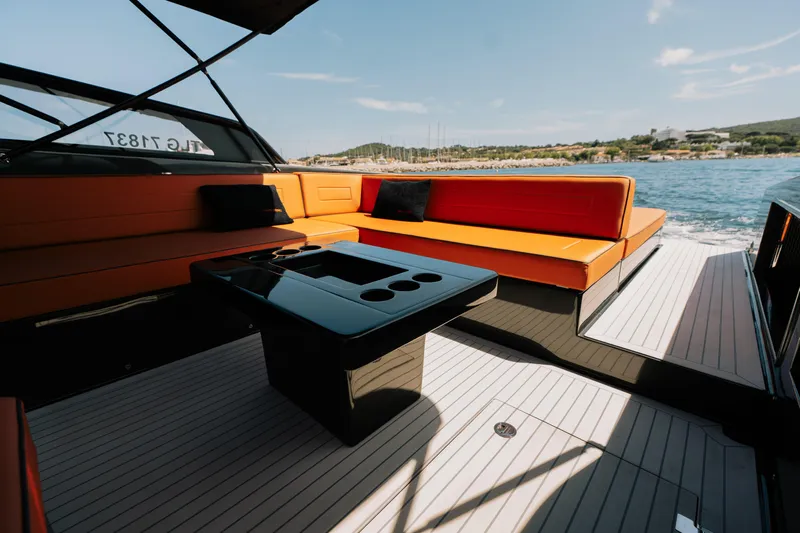 Must Yacht Photos Pics Luxurious 2024 VanDutch 40 yacht interior with orange seating and sleek black table.