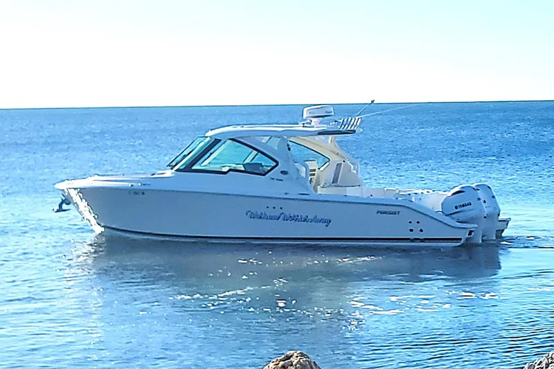  Yacht Photos Pics 2021 Pursuit DC 326 Dual Console boat on calm ocean waters.