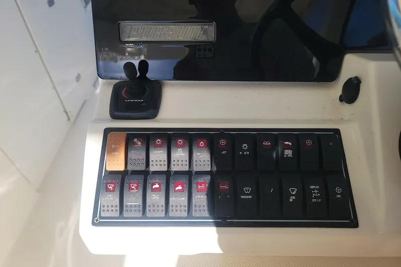  Yacht Photos Pics Control panel of 2021 Pursuit DC 326 Dual Console boat with various switches and joystick.