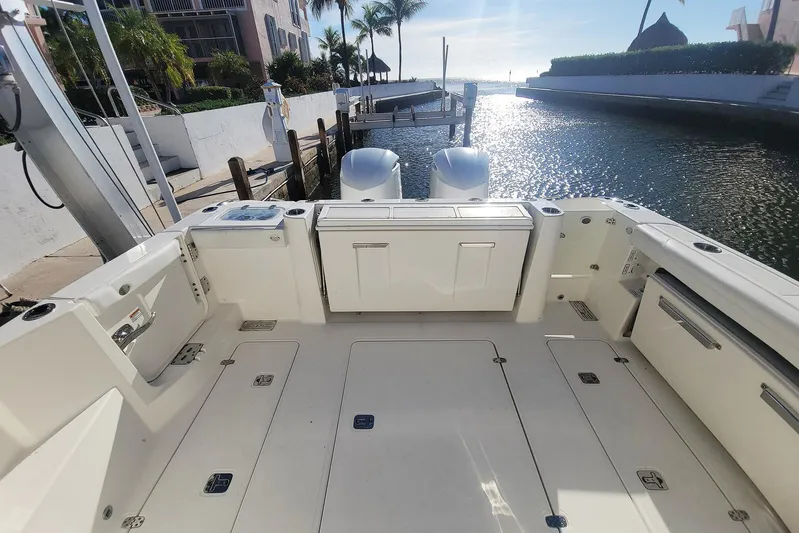  Yacht Photos Pics 2021 Pursuit DC 326 Dual Console boat docked, sunlit deck, and waterfront view.