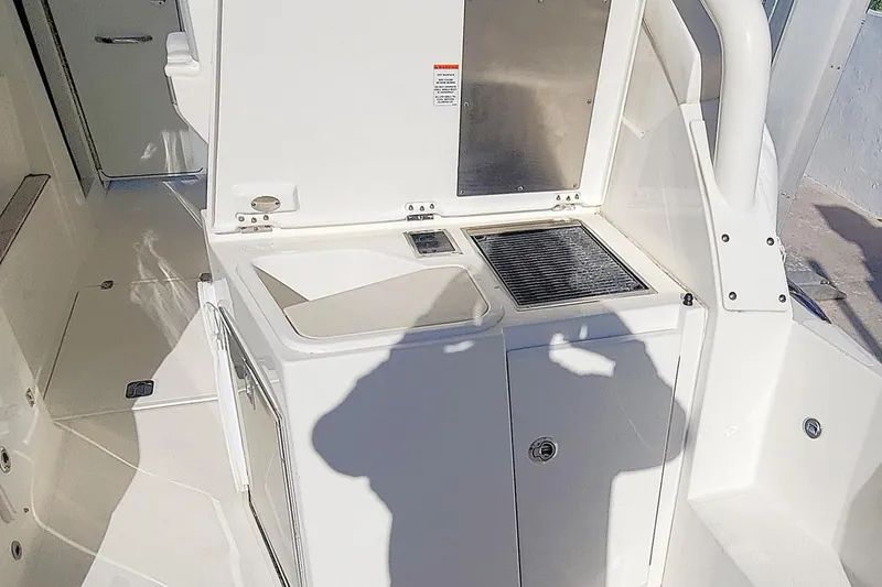  Yacht Photos Pics 2021 Pursuit DC 326 Dual Console boat interior with open storage and grill area.