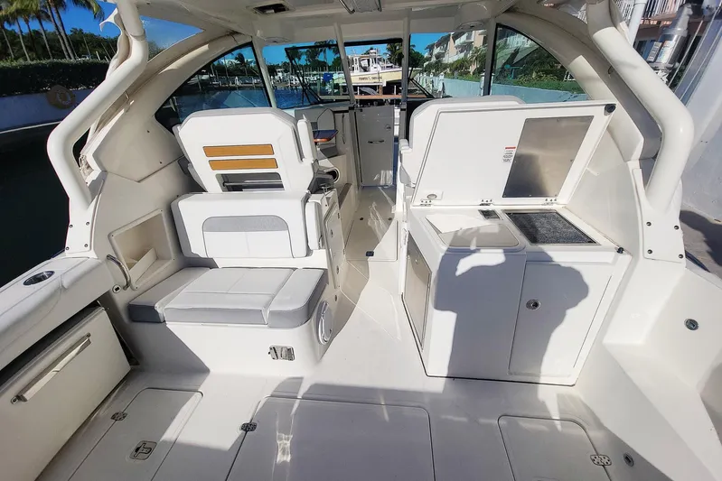  Yacht Photos Pics 2021 Pursuit DC 326 Dual Console boat interior with seating and kitchenette.
