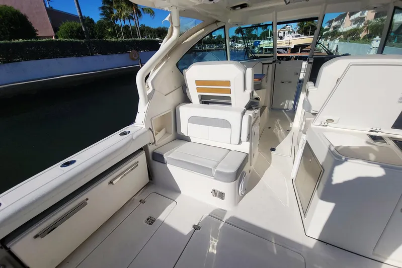  Yacht Photos Pics 2021 Pursuit DC 326 Dual Console boat interior with seating and storage compartments.