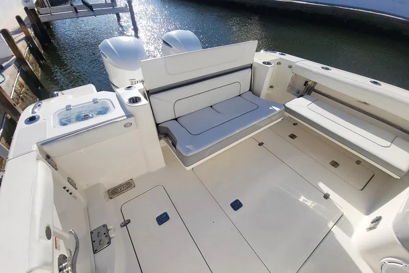  Yacht Photos Pics 2021 Pursuit DC 326 Dual Console boat interior with seating and storage compartments.