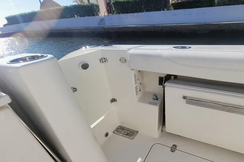  Yacht Photos Pics 2021 Pursuit DC 326 Dual Console boat interior with seating and storage, dockside view.