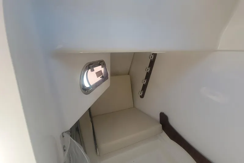  Yacht Photos Pics 2021 Pursuit DC 326 Dual Console cabin interior with seating and porthole.