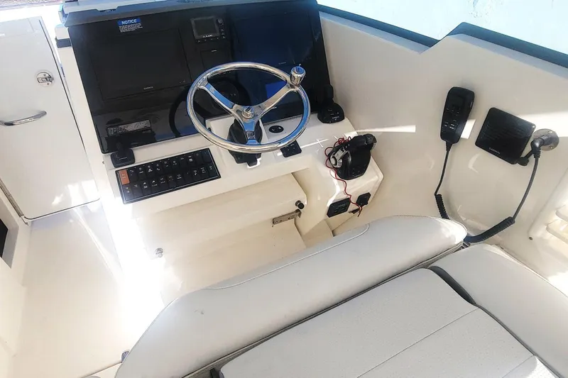  Yacht Photos Pics 2021 Pursuit DC 326 Dual Console helm with steering wheel and control panel.