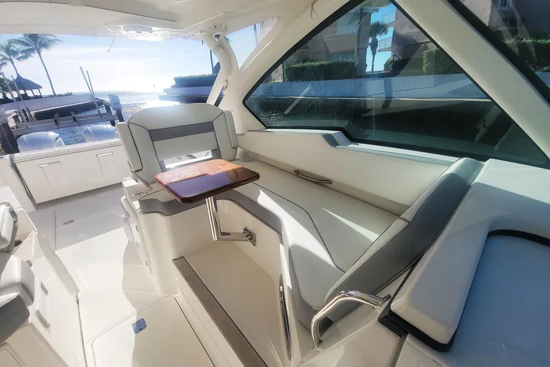  Yacht Photos Pics 2021 Pursuit DC 326 Dual Console interior with seating and table, overlooking water.