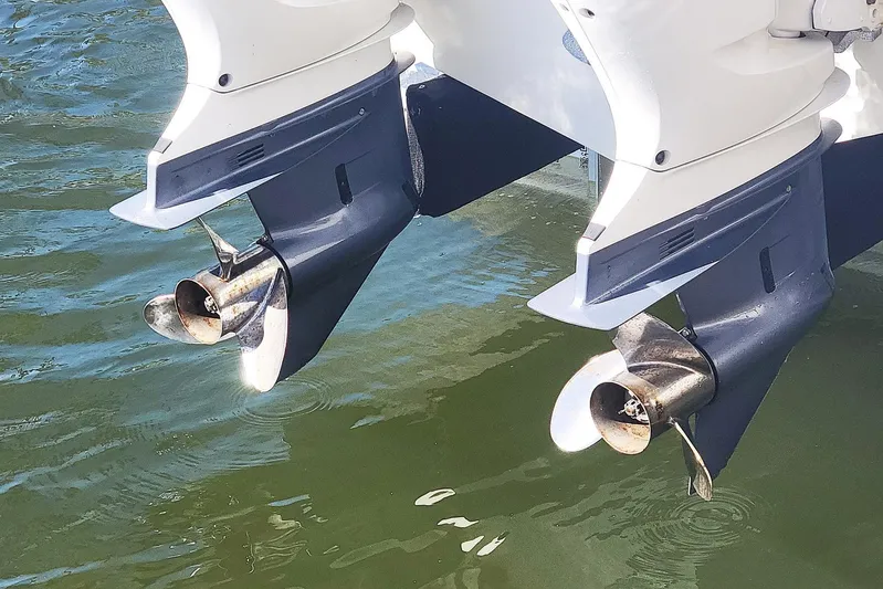  Yacht Photos Pics Twin outboard motors on a 2021 Pursuit DC 326 Dual Console boat in water.