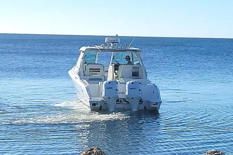  Yacht Photos Pics 2021 Pursuit DC 326 Dual Console boat cruising on open water.