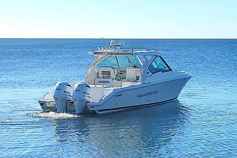  Yacht Photos Pics 2021 Pursuit DC 326 Dual Console boat cruising on calm blue waters.