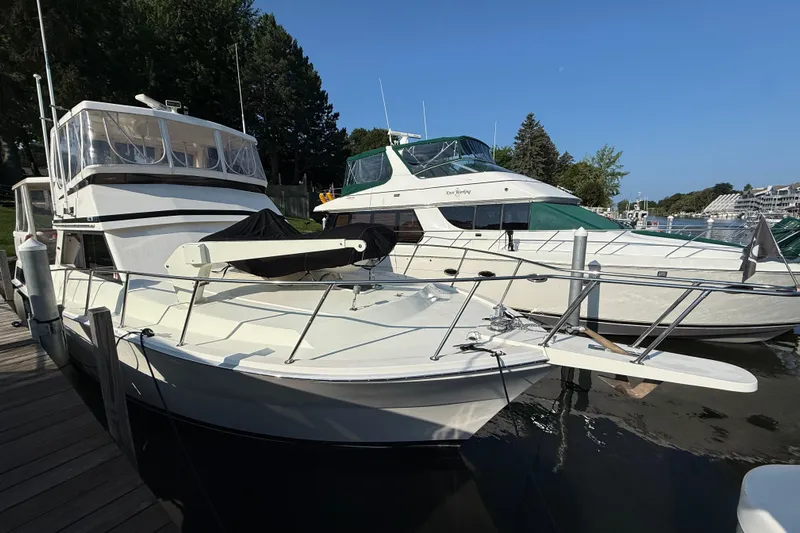 Last Dance Yacht Photos Pics 1989 Viking Boats 44 Motor Yacht docked alongside another vessel, under clear blue skies.