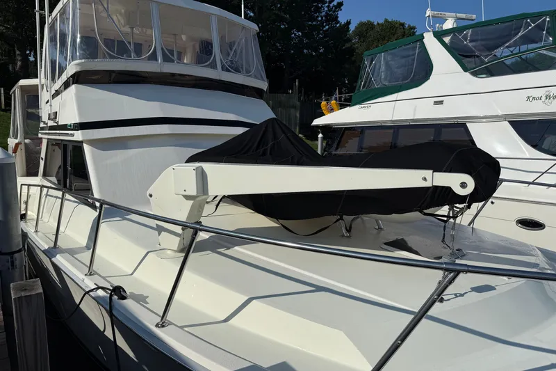 Last Dance Yacht Photos Pics 1989 Viking Boats 44 Motor Yacht docked, featuring sleek design and covered equipment.