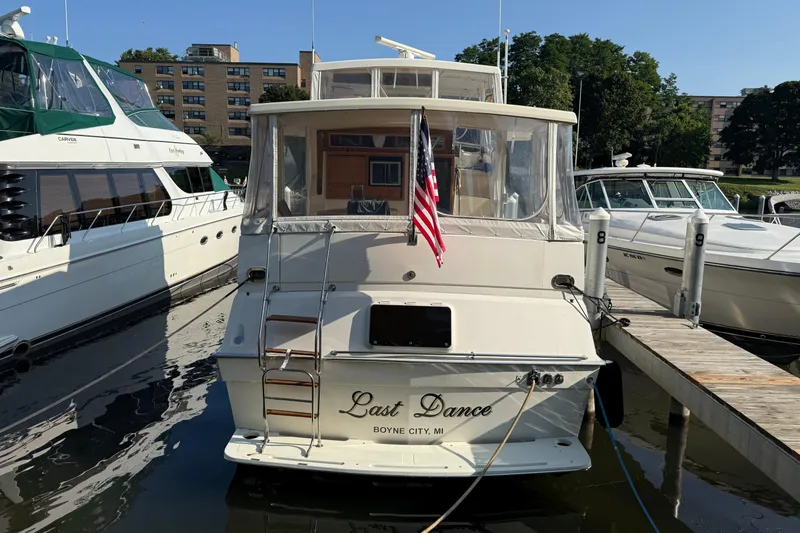Last Dance Yacht Photos Pics 1989 Viking Boats 44 Motor Yacht docked, rear view with American flag, "Last Dance" name visible.