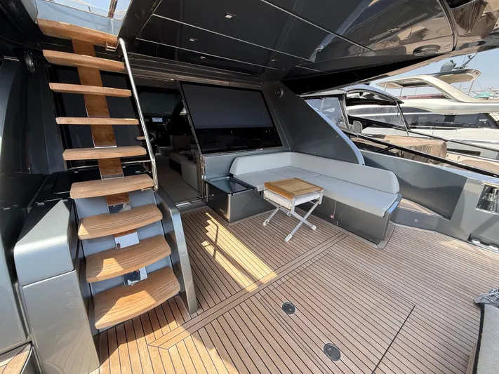  Yacht Photos Pics Luxurious 2022 Riva 76' Perseo Super yacht deck with seating and wooden stairs.