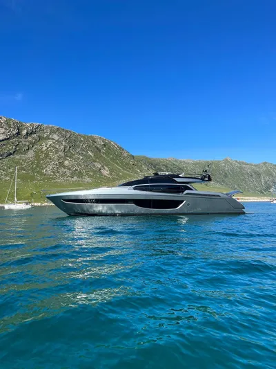  Yacht Photos Pics Luxury 2022 Riva 76' Perseo Super yacht on clear blue water, scenic mountain backdrop.