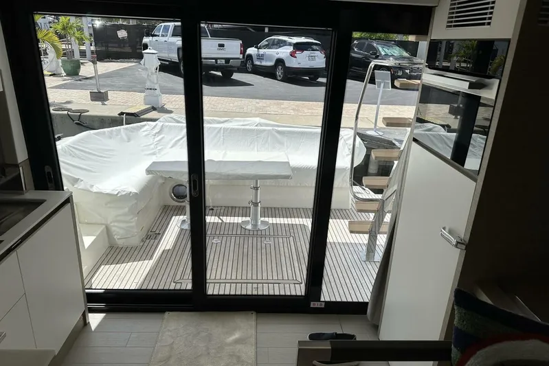 Our Trade Yacht Photos Pics 2024 Prestige 460 yacht interior with covered outdoor seating and modern design.