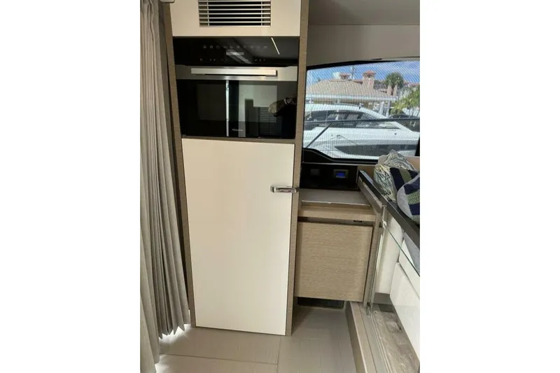 Our Trade Yacht Photos Pics Modern kitchen interior of 2024 Prestige 460 yacht with sleek cabinetry and appliances.