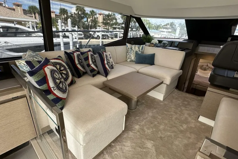 Our Trade Yacht Photos Pics Luxurious interior of 2024 Prestige 460 yacht with plush seating and nautical-themed pillows.